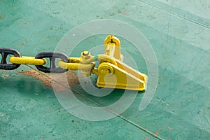 Anchor chain secured to stopper or pad-eye on construction barge