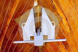 Anchor detail in silver color on a wooden hull