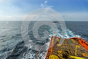 An anchor handling tug boat maneuvering at offshore oil field