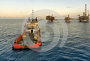An anchor handling tug boat maneuvering at offshore oil field