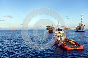 An anchor handling tug boat maneuvering at offshore oil field