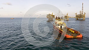 An anchor handling tug boat maneuvering at offshore oil field