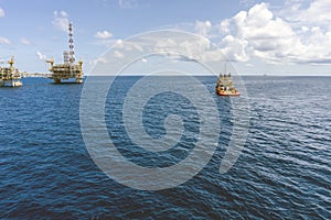 An anchor handling tug boat maneuvering at offshore oil field