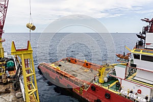 An anchor handling tug boat performing anchor handling activities at offshore oil field