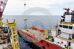 An anchor handling tug boat performing anchor handling activities at offshore oil field