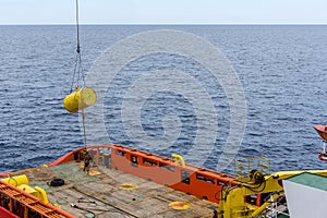 An anchor handling tug boat performing anchor handling activities at offshore oil field