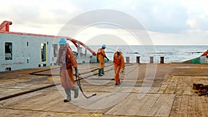 Anchor-handling Tug Supply AHTS vessel crew preparing vessel