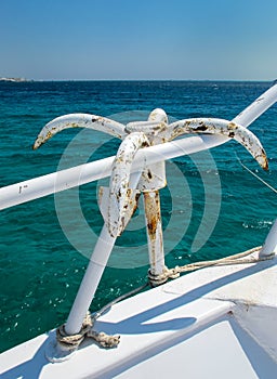 Anchor Hanging on the Handrail of a Yacht