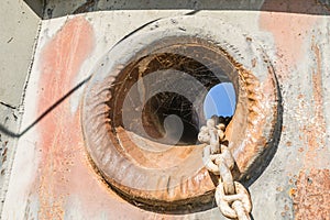 Anchor hole with a chain of an old stranded ship