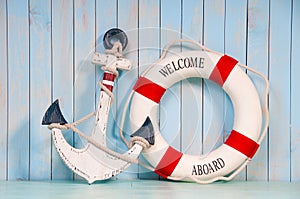 Anchor and life buoy on a background of shabby wall boards