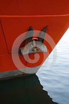 One black anchor on red ship