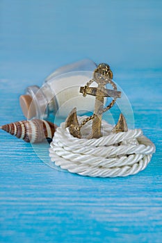 Anchor with rope on wooden background