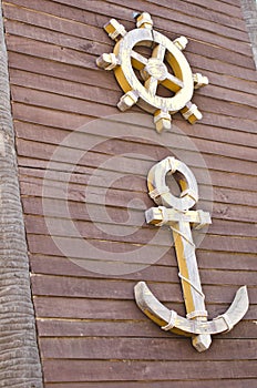 Anchor and steering wheel symbol.
