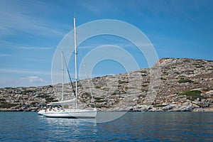 Anchorage of a sailing boat near a small island in the Aegean Sea