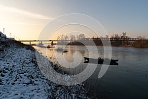 Anchored boats in river during sunset