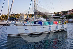 Anchored sailboat off the coast of the KASTOS island, Ionian Islands, Greece in summer evening.