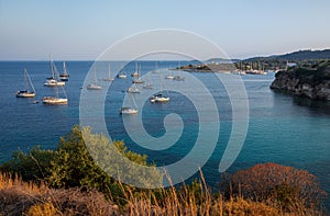 Anchored sailboats off the coast of Kastos island, Ionian sea, Greece in summer.