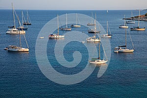 Anchored sailboats off the coast of Kastos island, Ionian sea, Greece in summer.