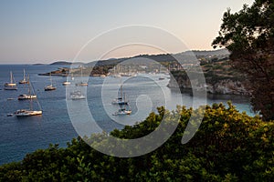 Anchored sailboats off the coast of Kastos island, Ionian sea, Greece in summer.