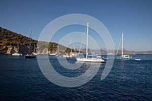 Anchored sailboats off the coast of the KASTOS island, Lefkada Regional unit, Ionian Islands, Greece in summer morning.