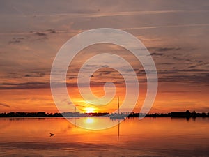 Anchored sailboats at sunset on Lake De Morra, Friesland, Netherlands