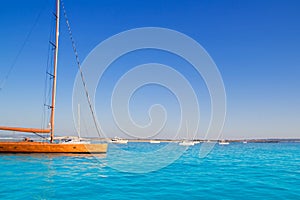 Anchored sailboats in turquoise Formentera beach