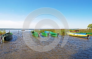 Anchored wooden boats in small bay