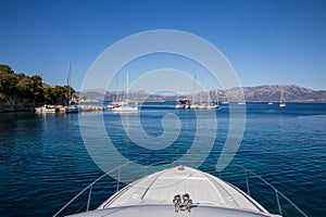 Anchored yacht and sailboats off the coast of the KASTOS island, Ionian Islands, Greece in summer morning.