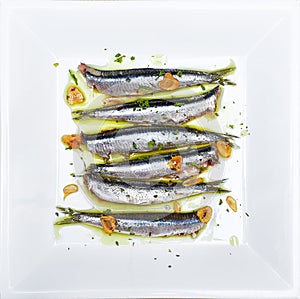 Anchovies marinated in olive oil, cooked at a low temperature.