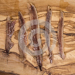 Anchovy fillets on wood