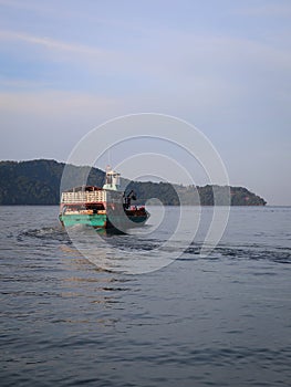 an anchovy fishing boat sailing to open sea photo