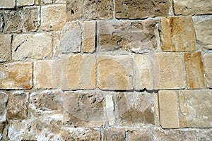 Ancien wall from brown stones front view close up