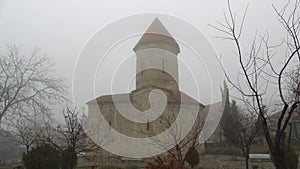 The ancient Albanian Church of Saint Elisha in january on a foggy day. Kish village, Azerbaijan