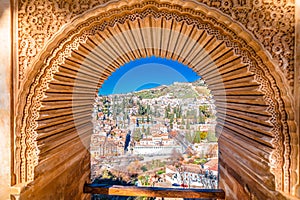 Ancient Albayzin neighbourhood of Granada view through Alhambra stone window