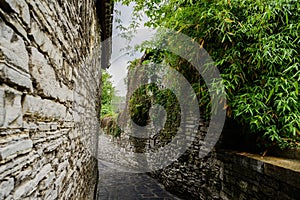 Ancient alley with stone-stacked walls in cloudy spring,China