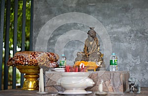 Ancient altar with monkey statue and gifts in the temple. Thailand