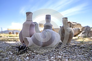 Ancient amphoras against the backdrop of the ruins of the historic city of Zipory, Israel. Tourism and travel