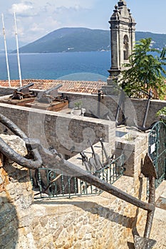 ancient anchor adorning Maritime Museum, an old bell tower a