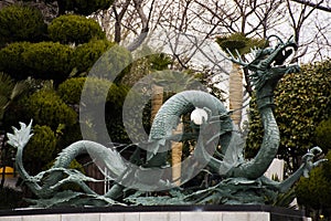 Ancient antique art dragon statue in garden for korean people and foreign travelers use eat drinks in Diamond Busan Tower and