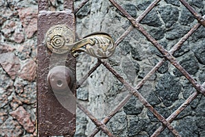 Ancient antique bronze door with iron chain knob.