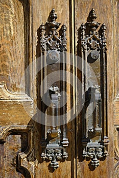 Ancient Antique Door Handles on Old Worn Wooden Doors