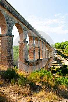 Ancient aqueduct in sunny day