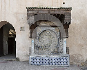 Ancient Arabic mosaic fountain at one of the entrances to the Souk Myknes, Morroco.