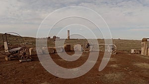 Ancient Arabic well and wooden carts, desert, live camera, the tower in the distance