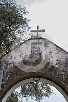 Ancient arch with a cross and archangel Michael painting.