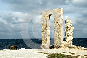 Ancient arch - ruins over seashore