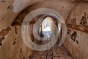 Ancient arched passage on a narrow paved historical street in Old Jaffa, Tel Aviv, Israel