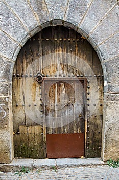 Ancient architecture with arch, old doorway, and no people present. Captivating and serene