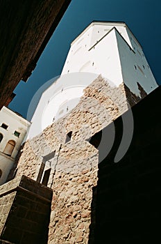 Ancient architecture concept. Old stone tower in Vyborg, Russia in sunny summer day seen from below