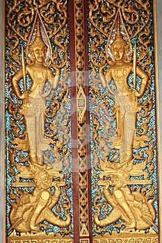 Ancient art pattern on the wooden door in Thai temple